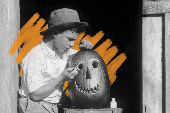 Boy carving jack-o’-lantern