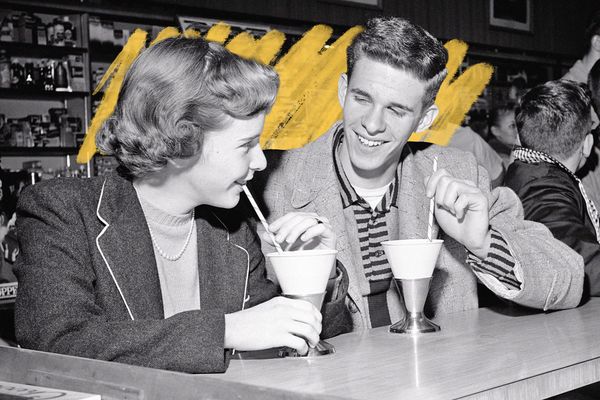 Teenage couple at soda counter, 1950s