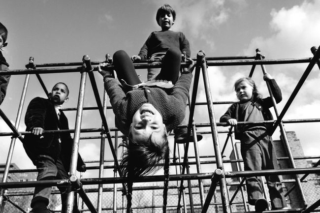Kids on jungle gym bars, 1970s